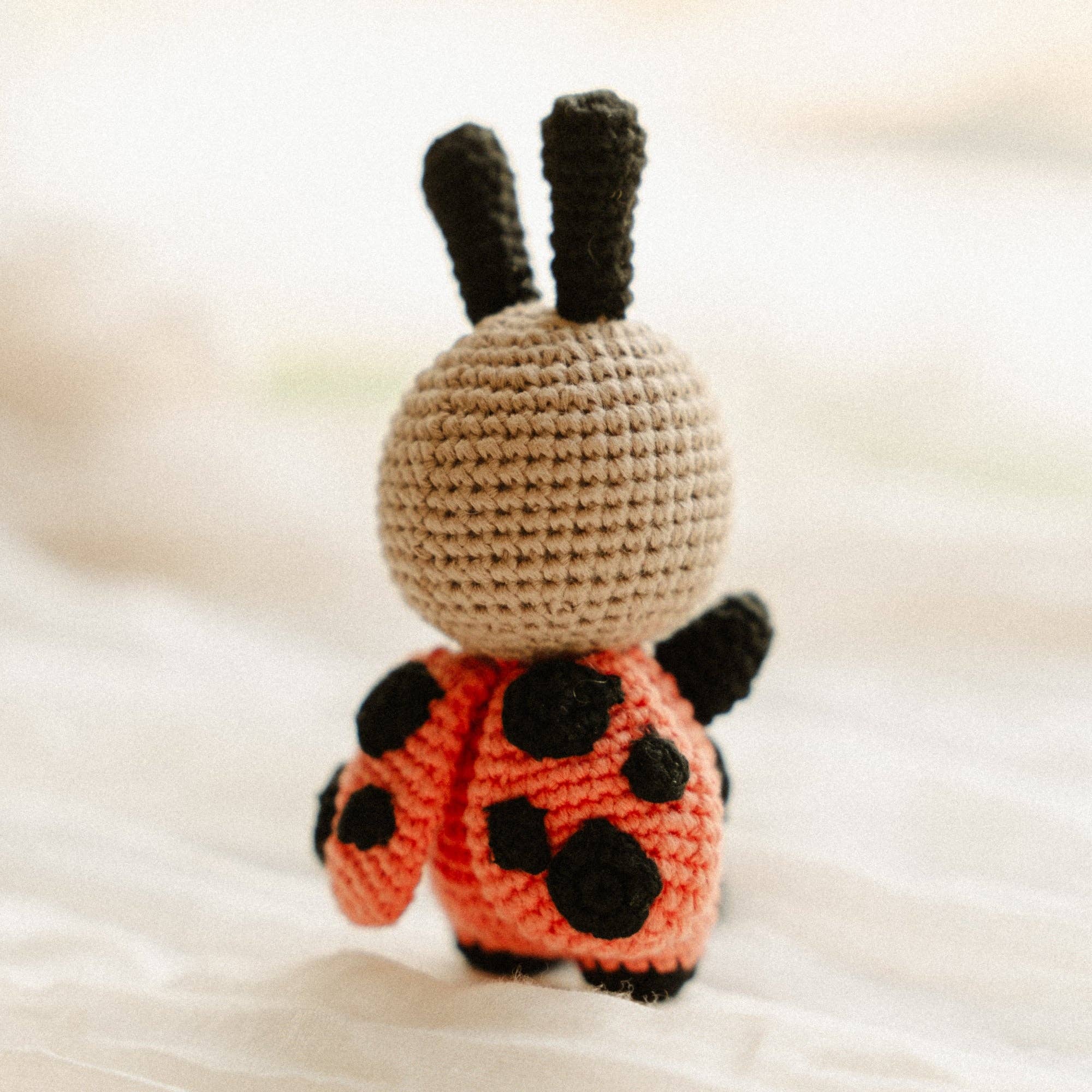 Suzie the Snuggle Buggle, a cute crochet ladybug toy, perfect for babies and toddlers for snuggling and play.