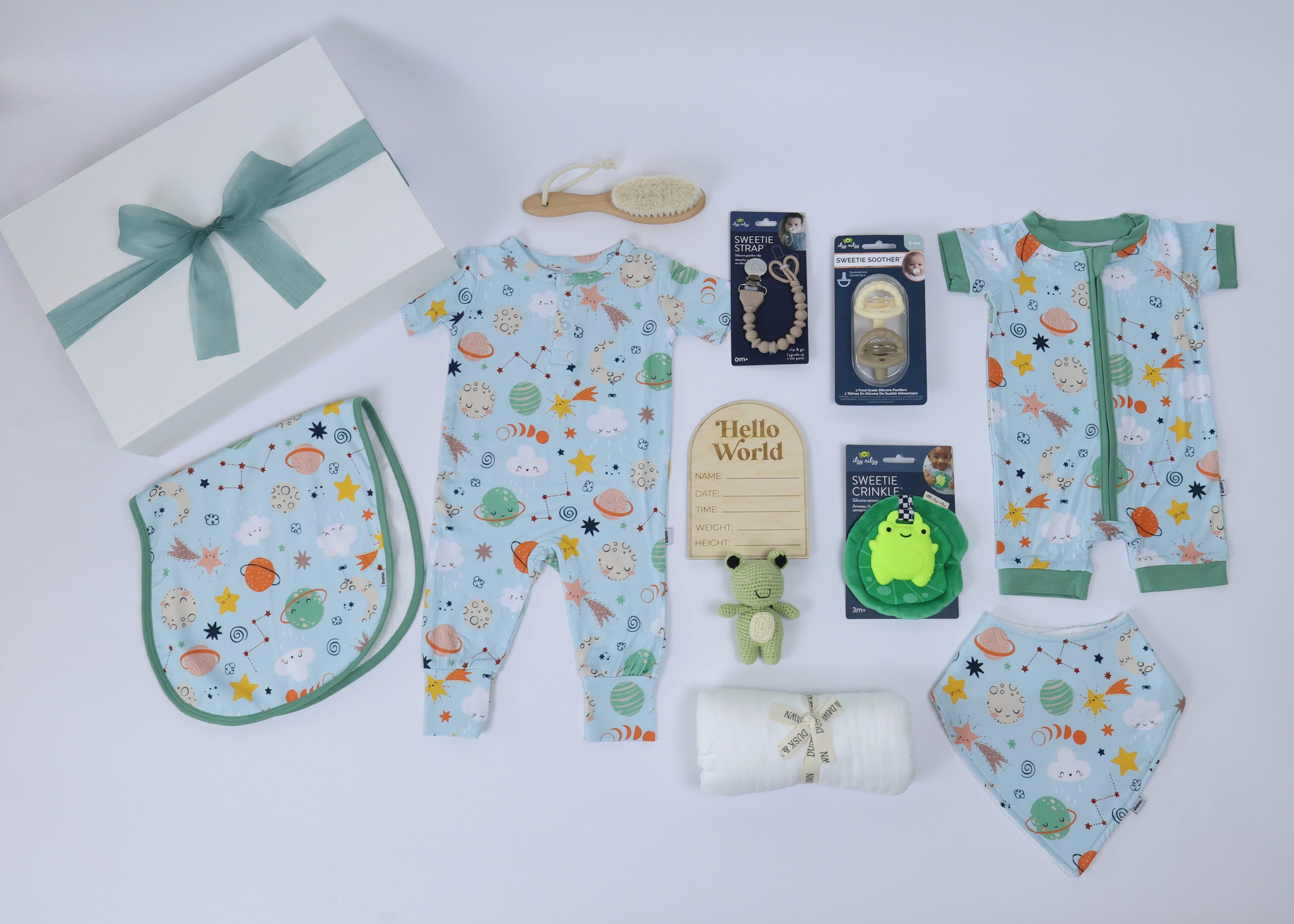 Newborn gift set for boys, featuring clothes, toys, and accessories, all in a soft, eco-friendly theme.
