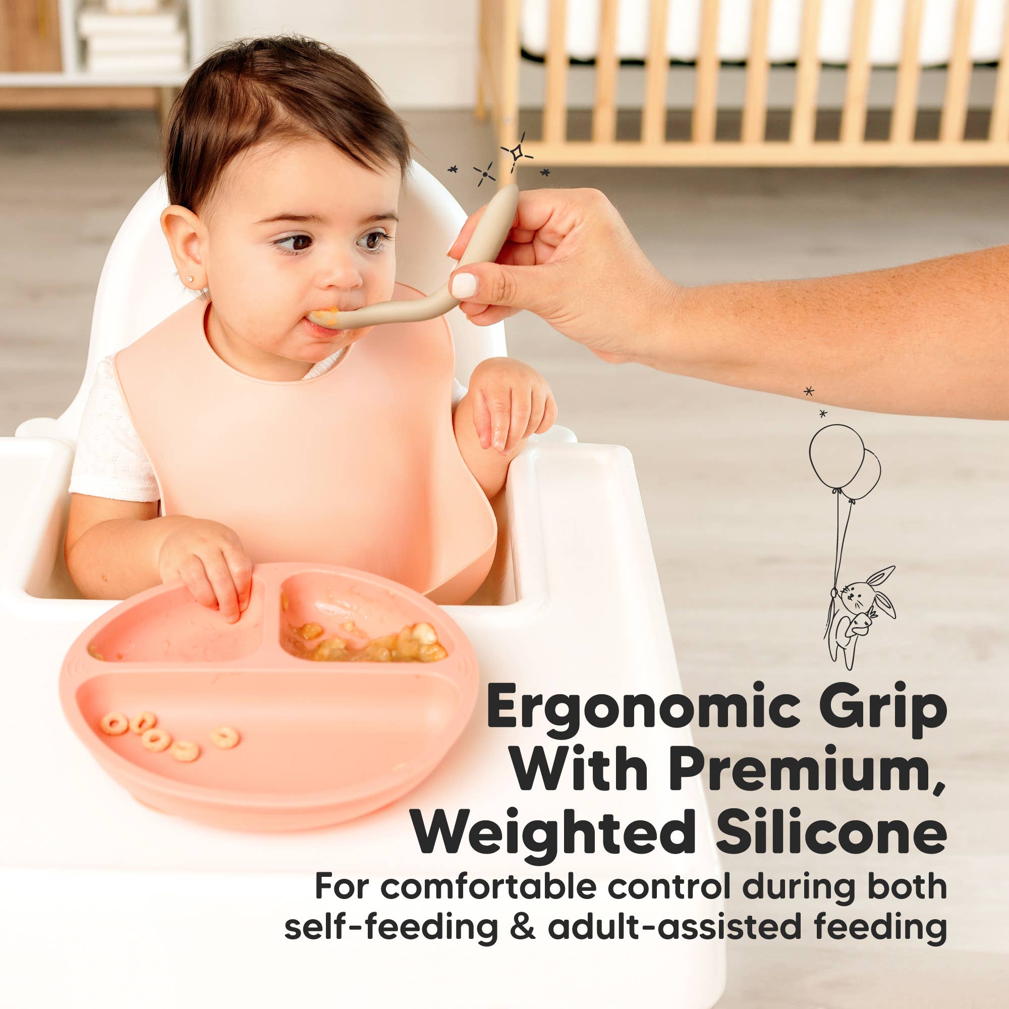 Toddler using ergonomic baby spoon with weighted silicone for easy grip and self-feeding in high chair.