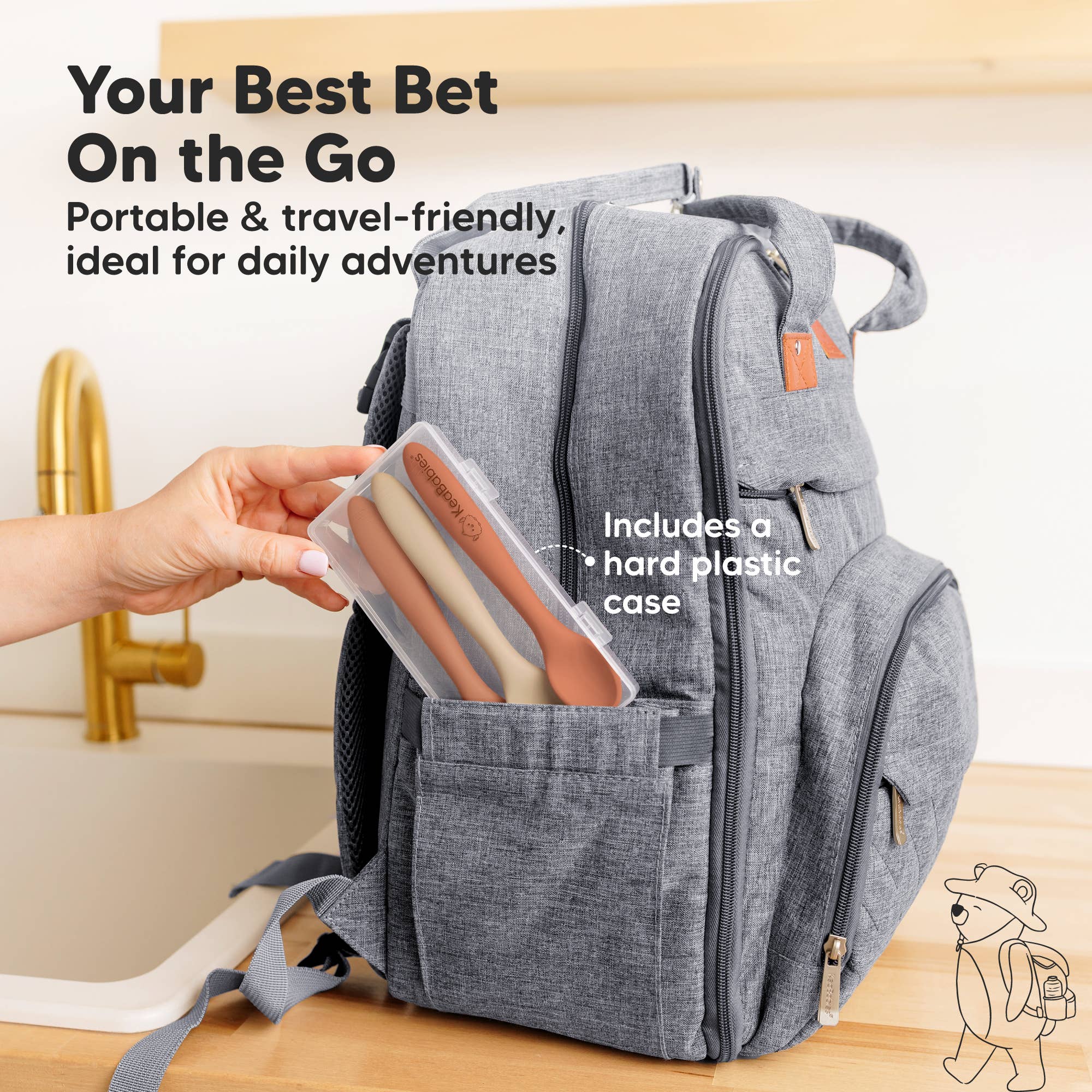 Stylish gray backpack with baby utensils in plastic case, perfect for on-the-go feeding adventures.