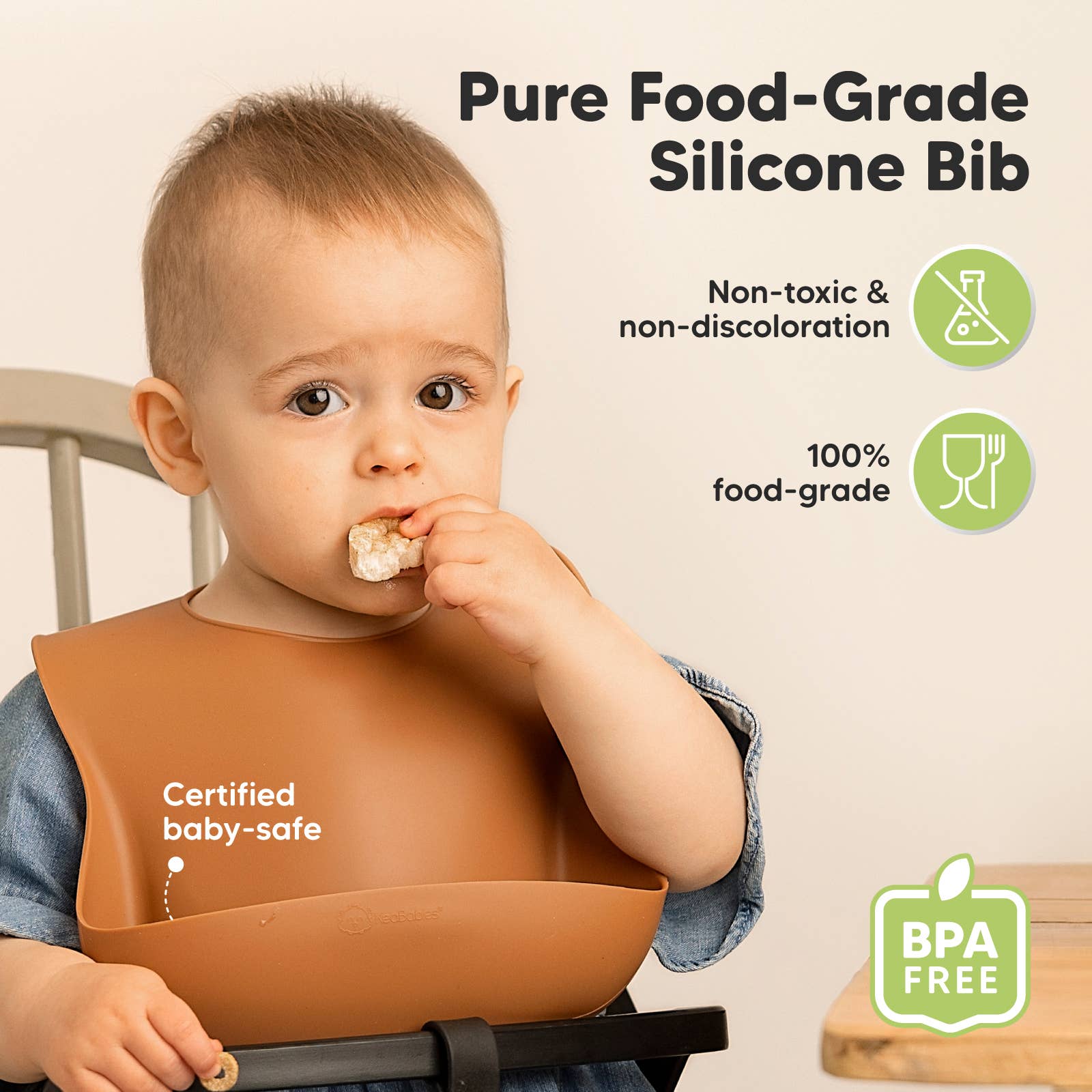Young child wearing a food-grade silicone bib, certified baby-safe and BPA-free, enjoying a snack.