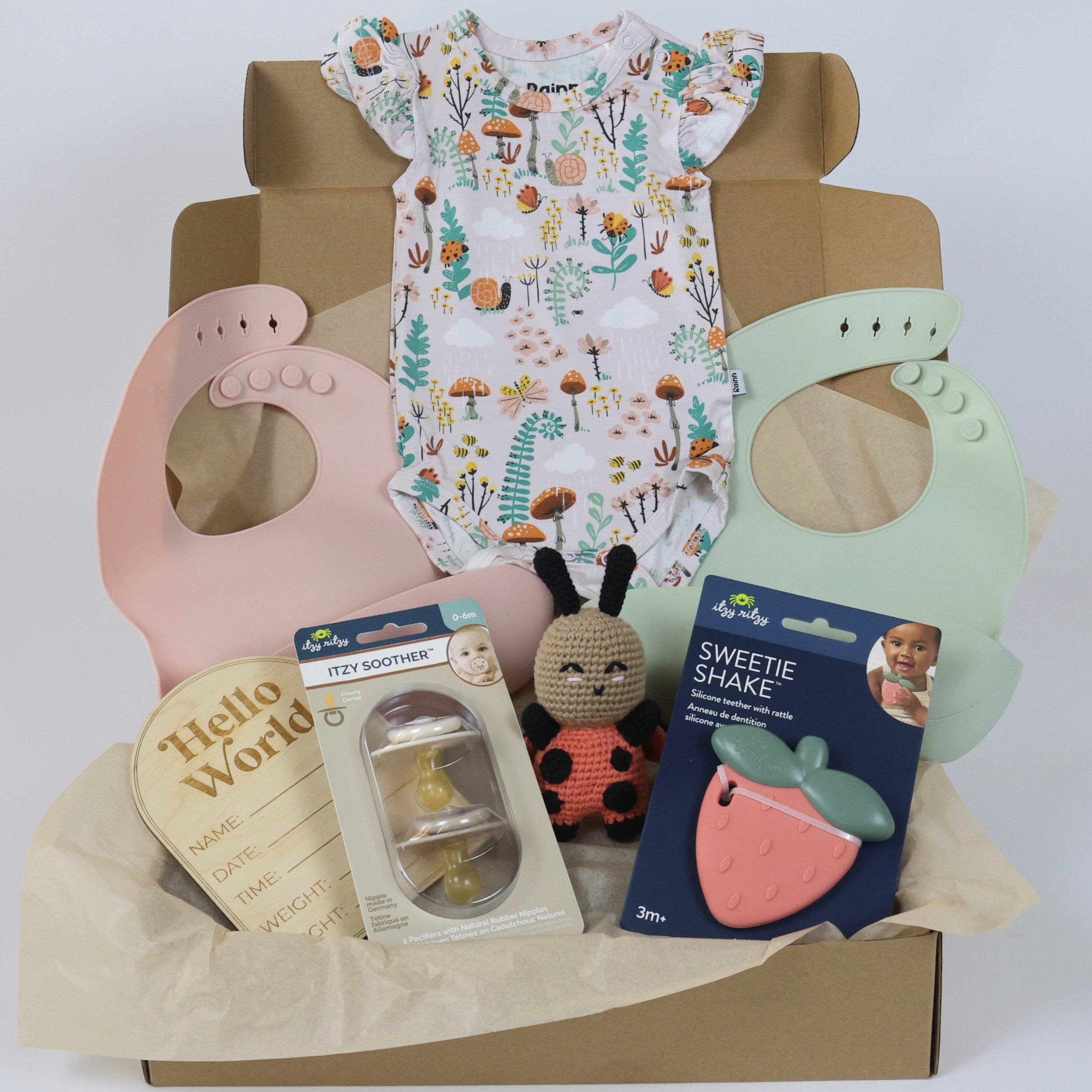 Toddler Gift Set for girls featuring a floral onesie, bibs, toys, and baby accessories in a gift box.