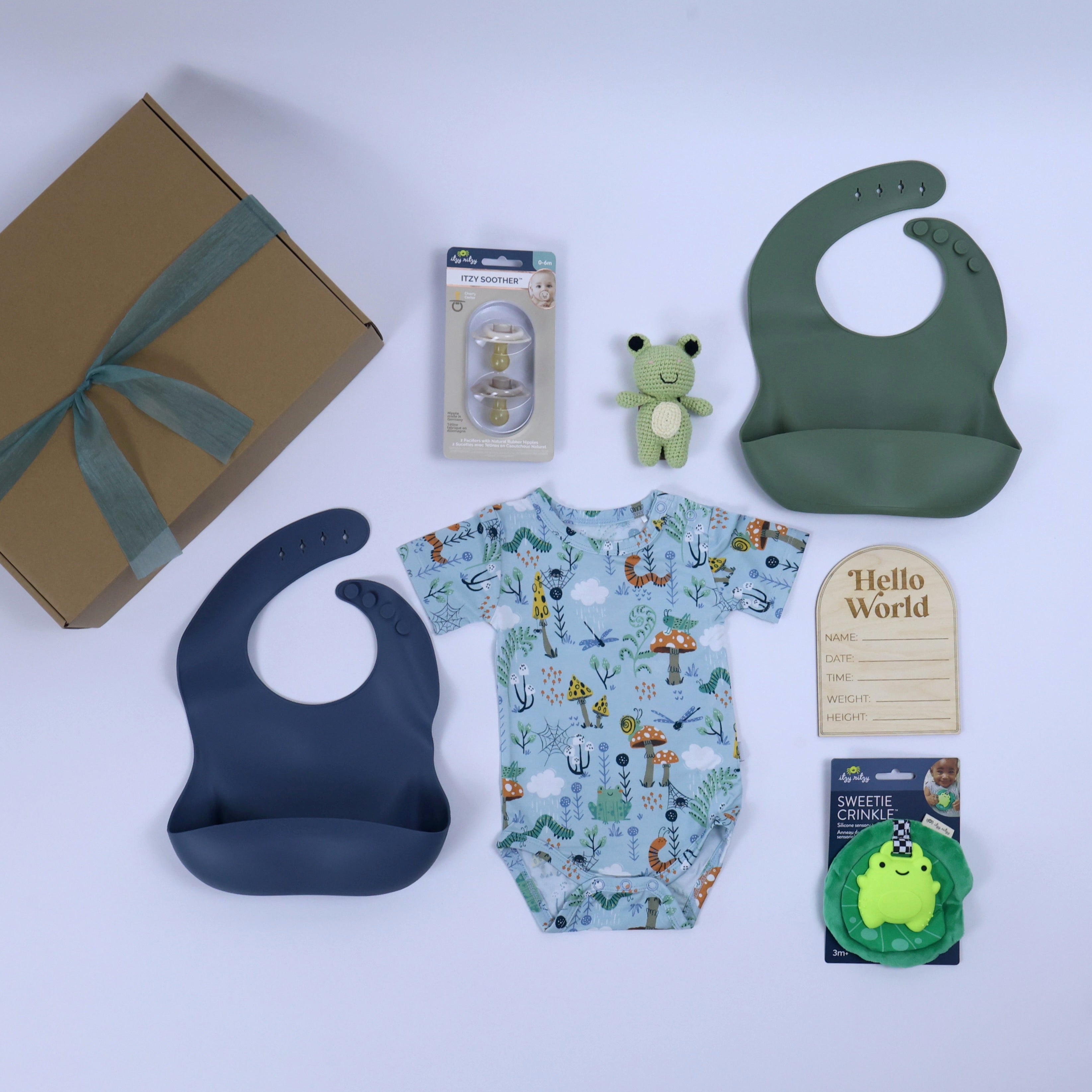 Toddler gift set for boys featuring a colorful onesie, silicone bibs, plush toy, and accessories for snack time.