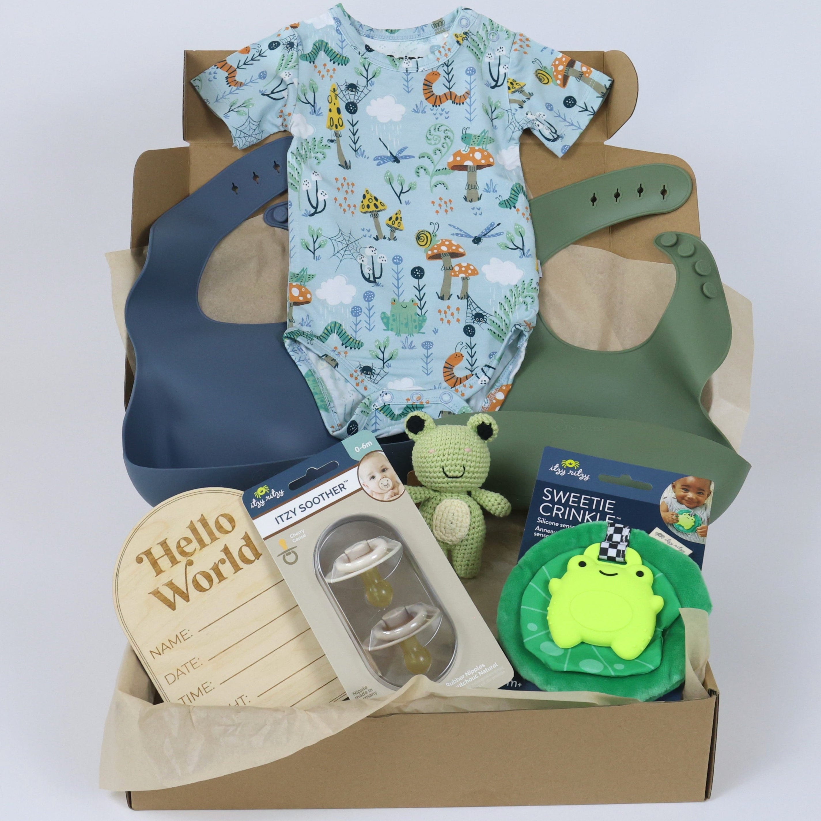 Toddler gift set for boys featuring bamboo onesie, bibs, soft toys, and accessories in a decorative box.