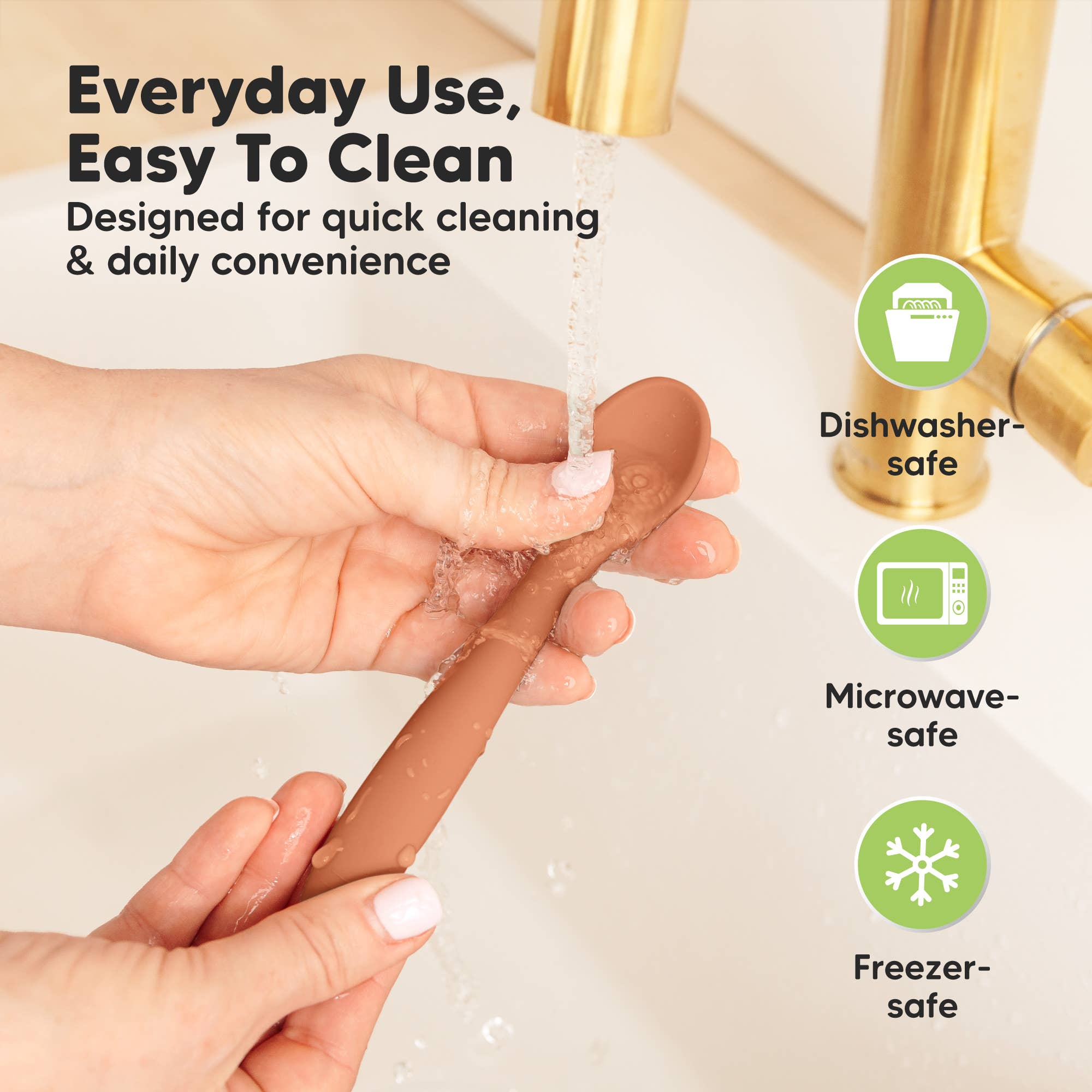 Hands washing a silicone baby spoon under water with icons for dishwasher, microwave, and freezer safe.