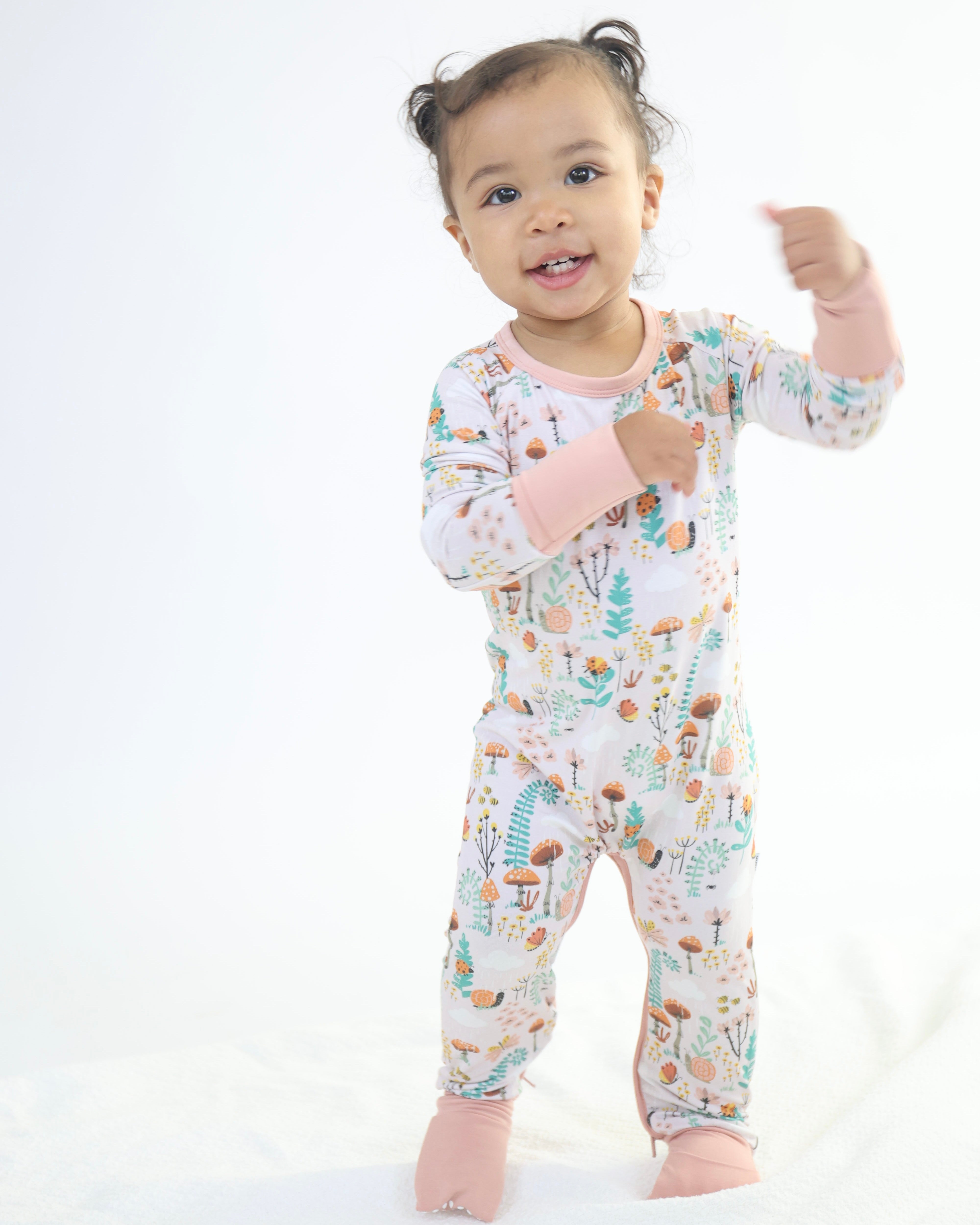 Baby in colorful bamboo Crescent Zipp Jammies by Rainn, perfect for comfy and eco-friendly sleep.